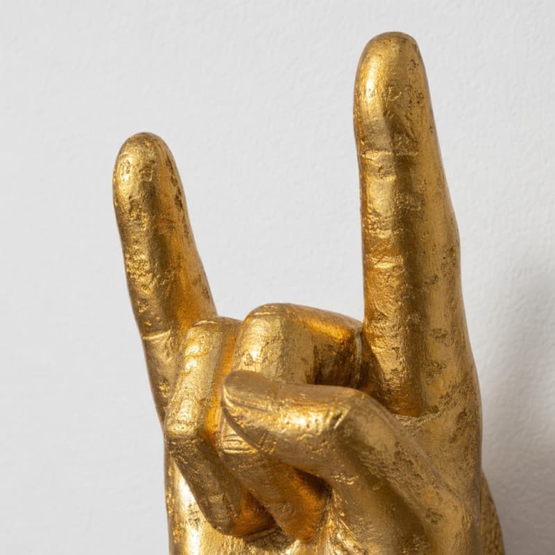 Seitliche Detailansicht der goldenen Wandhand