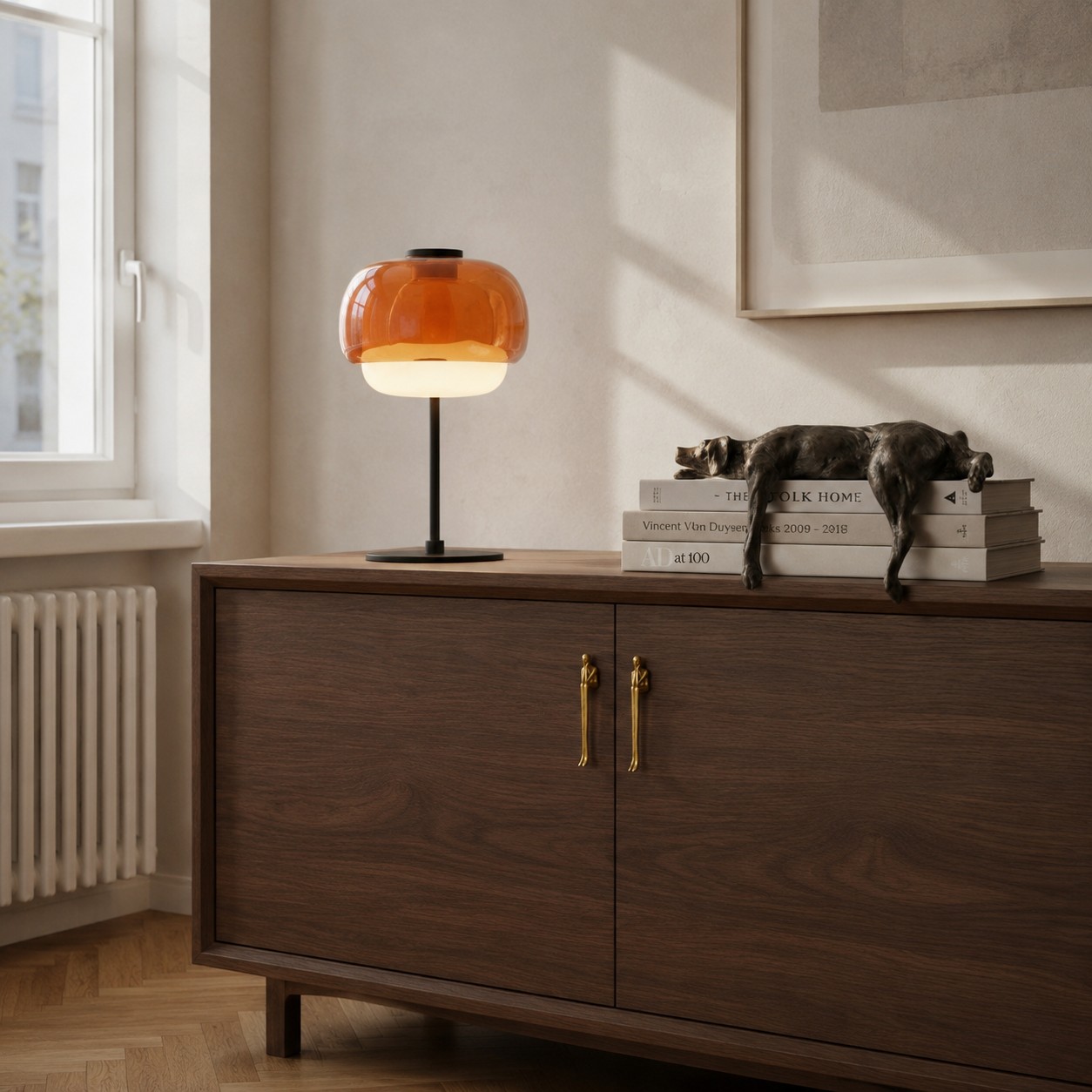 LUMES Design orange glass table lamp on a walnut cabinet