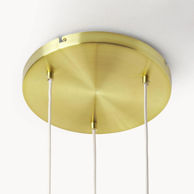 Close-up of brushed metal canopy with suspension cables and cord exits