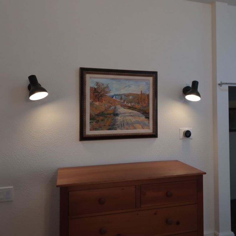 Kundenbild mit schwarzen Wandlampen über einer Kommode