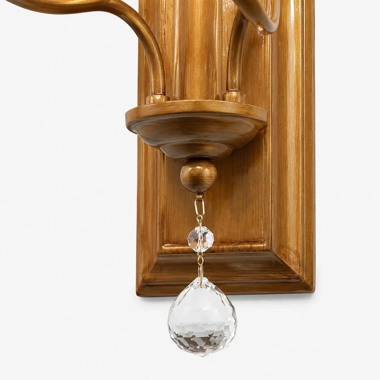 Close view of brass lower frame and hanging crystal drop
