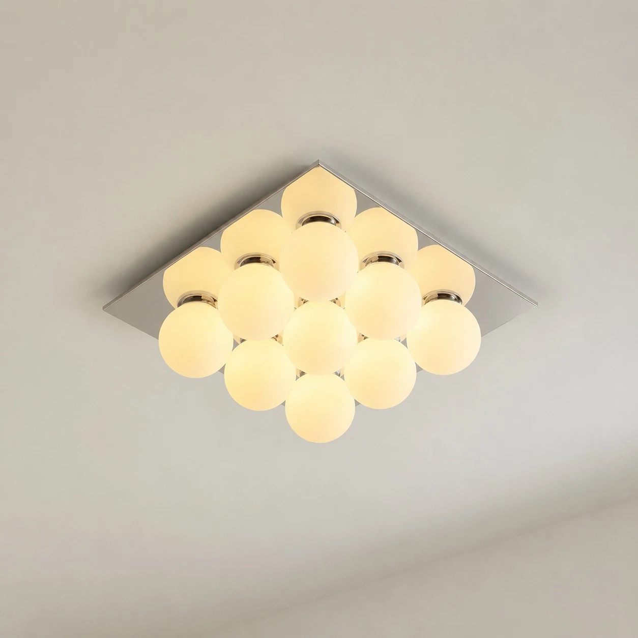 Gallery image: nine glowing glass globes under a square chrome canopy.