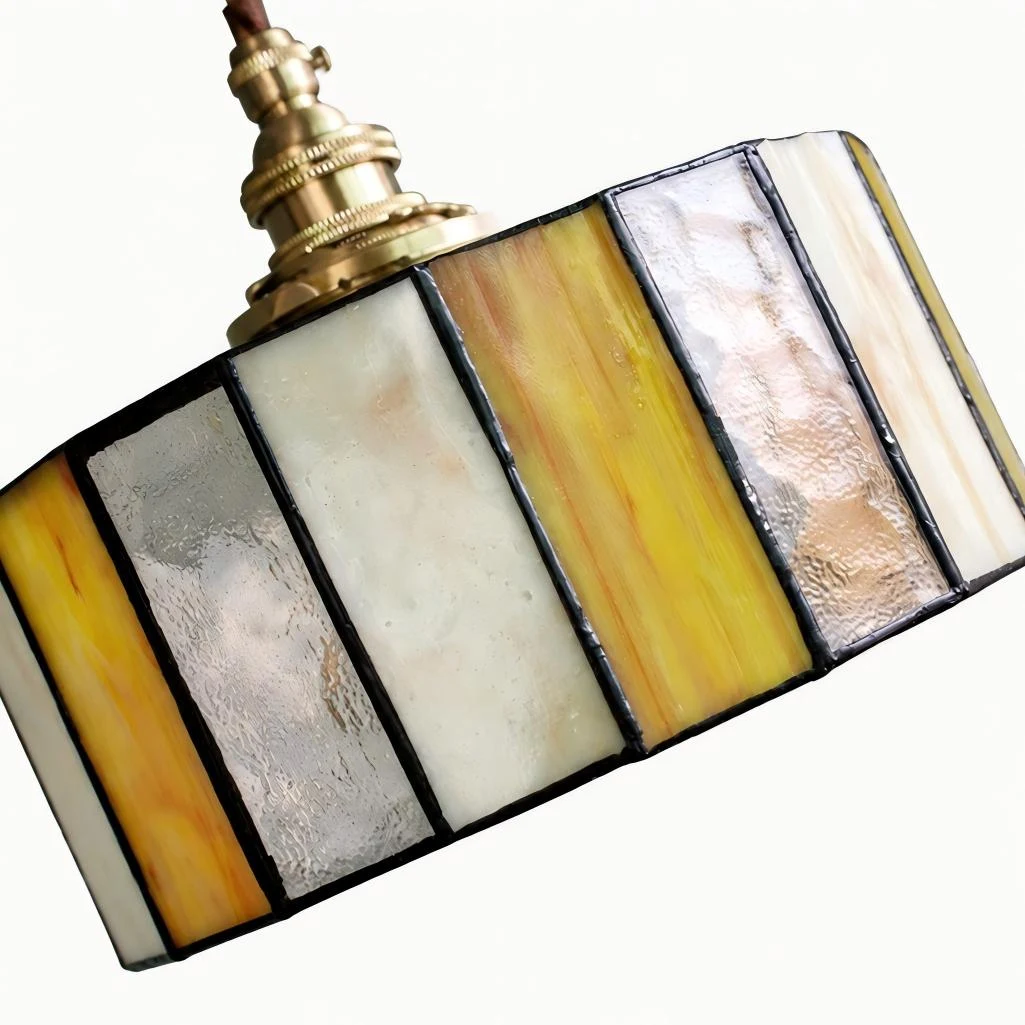 Close view of the stained glass pendant shade with brass socket and textured panels
