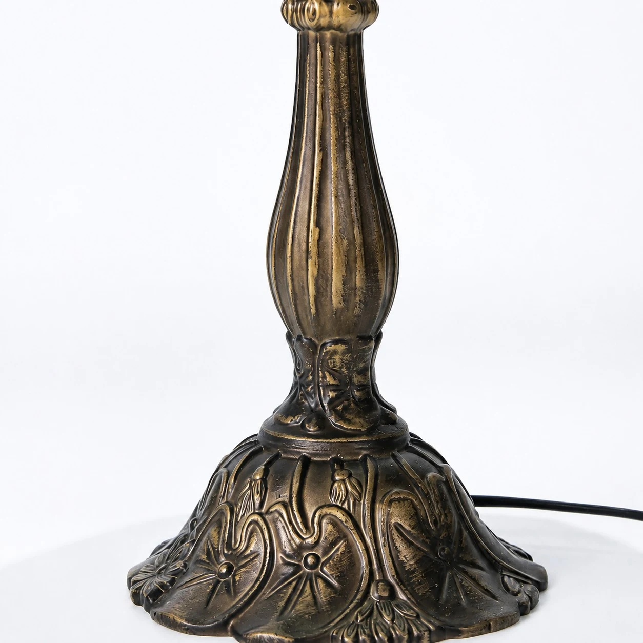 Antique-tone sculpted lamp base detail