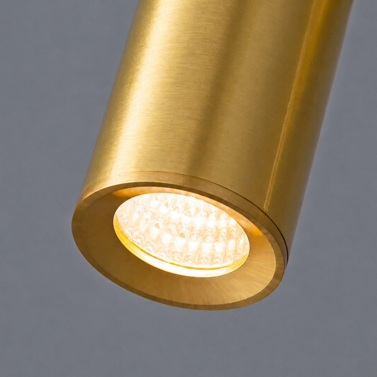Lit brass spotlight head close view