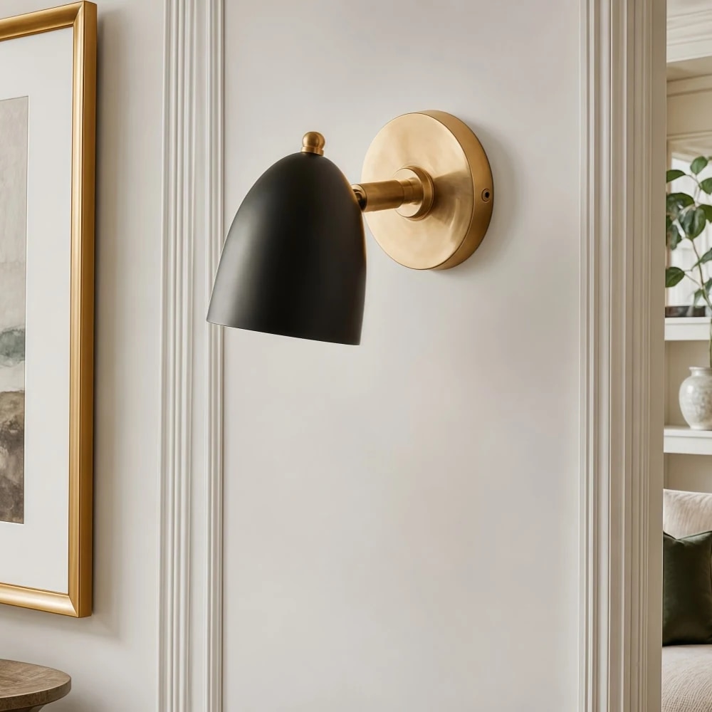 Black and gold wall sconce on a refined wall