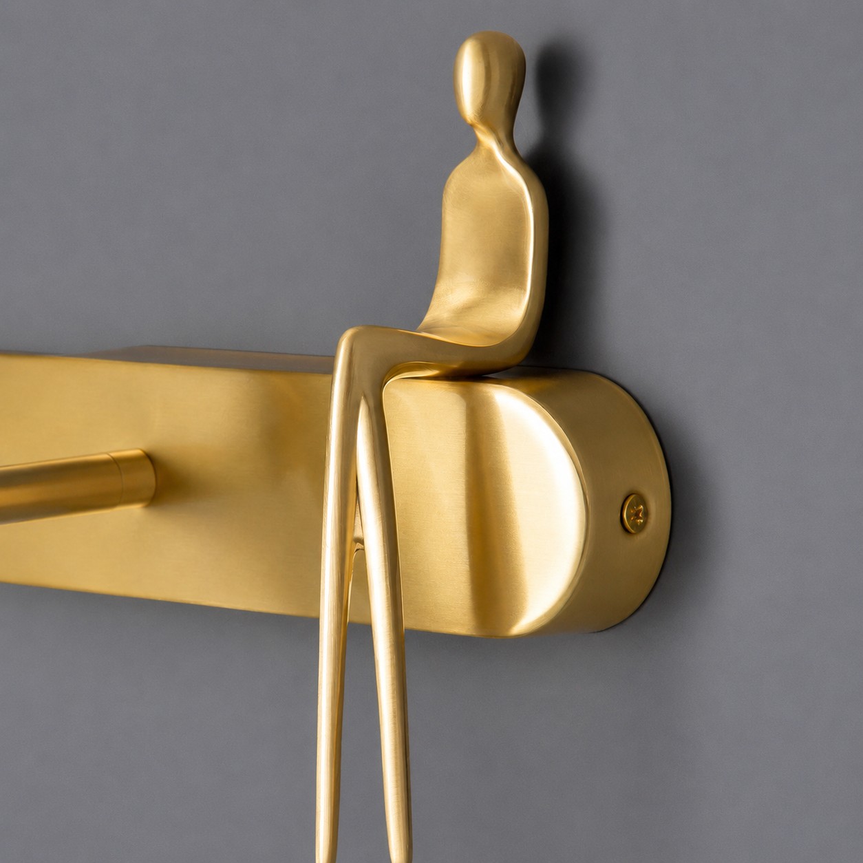 Brass wall plate with decorative figure