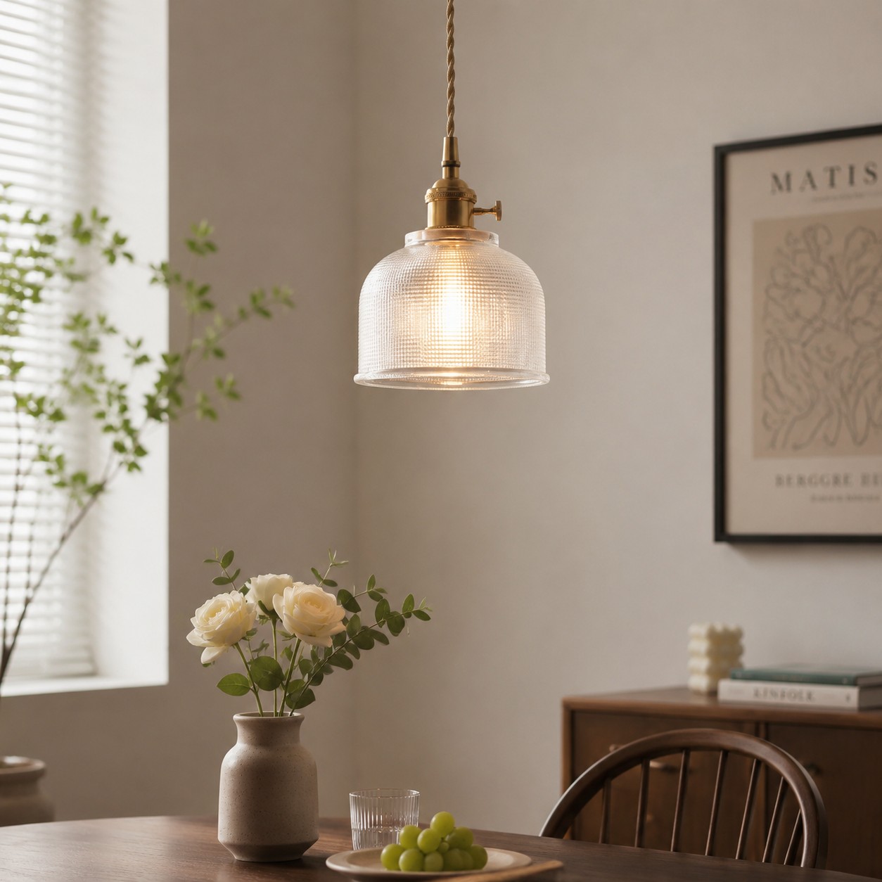 Room scene showing the rounded ribbed pendant above a table