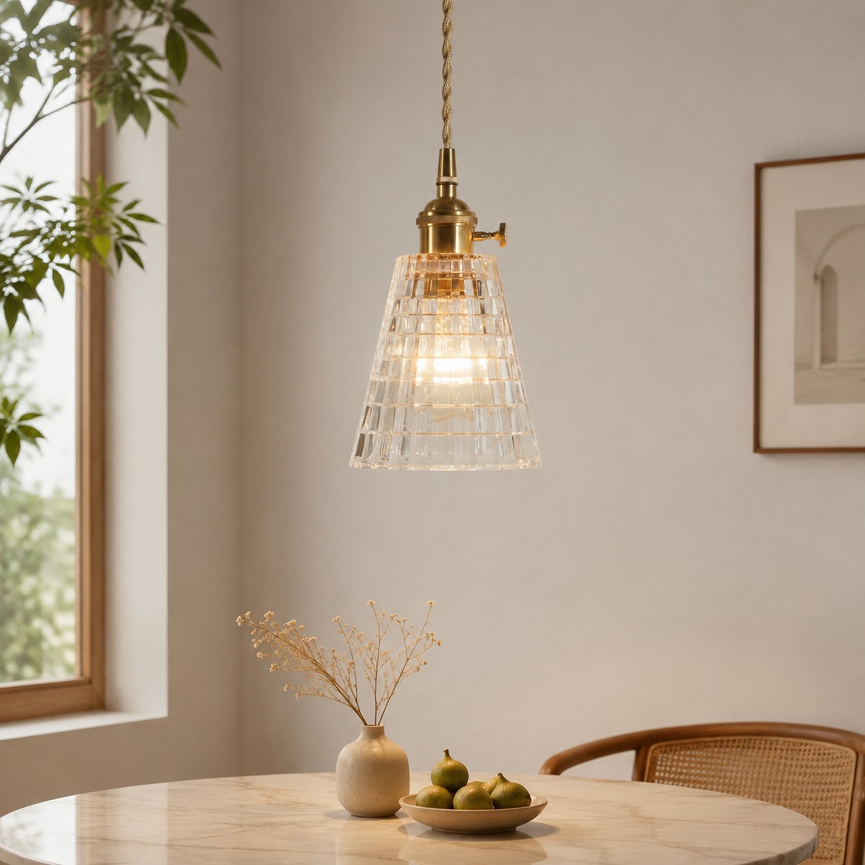 Lifestyle dining scene with the clear square-grid pendant illuminated