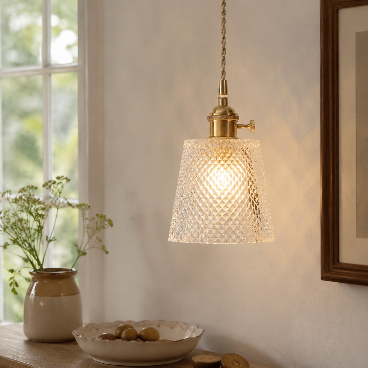 Lifestyle room scene showing one illuminated pendant against a wall