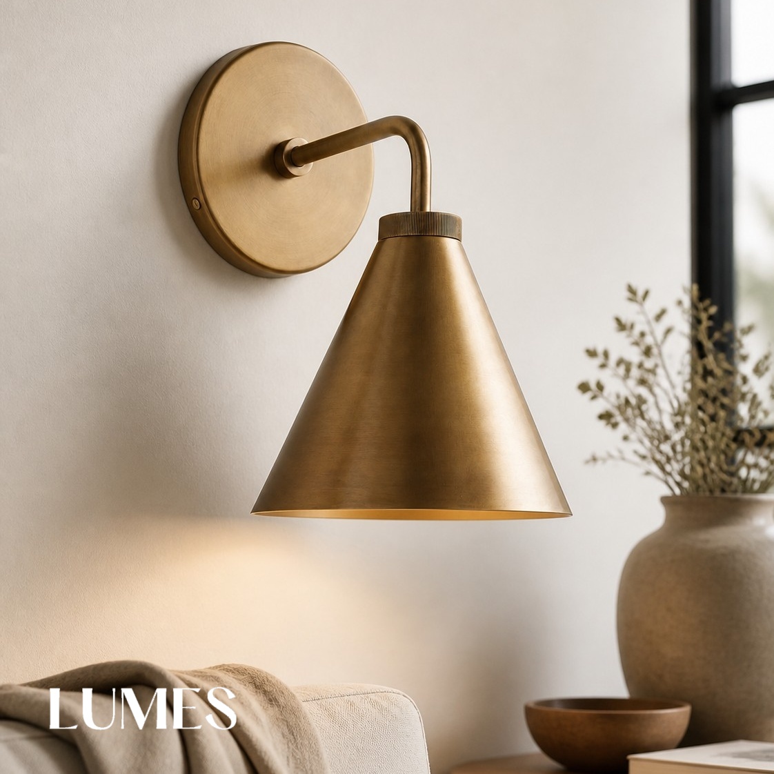 Close room scene with brass Korvi wall lamp