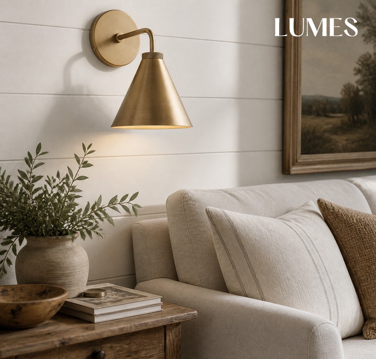 Korvi brass wall lamp above living room seating
