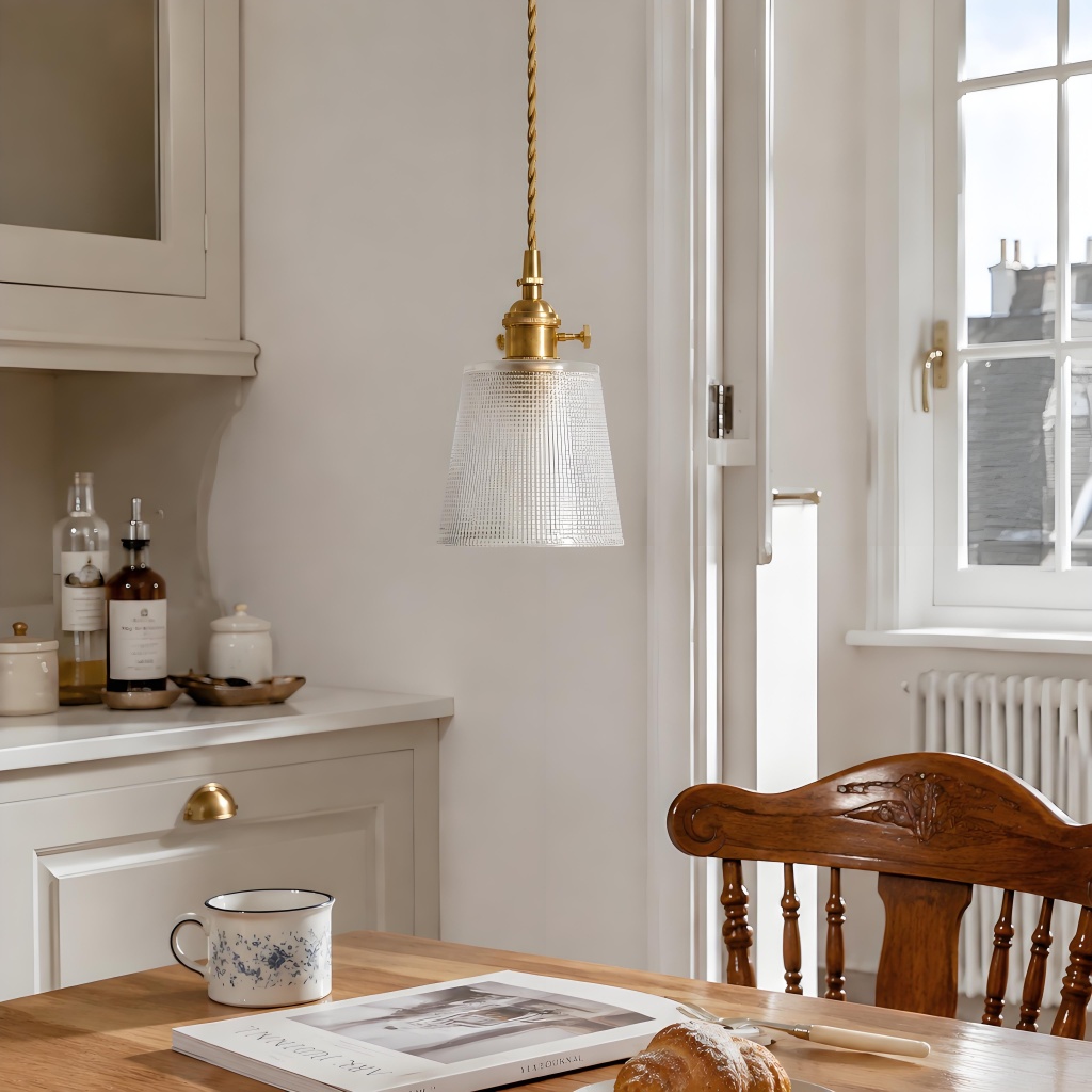 Dining and kitchen scene showing the ribbed cylindrical pendant in use