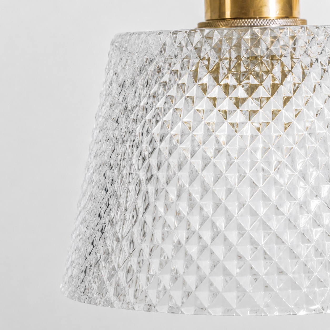 Isolated product view showing brass fitting, chain, and textured glass shade