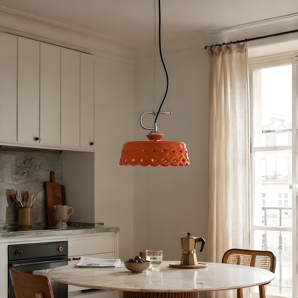 Orange pendant lamp centered in bright kitchen scene