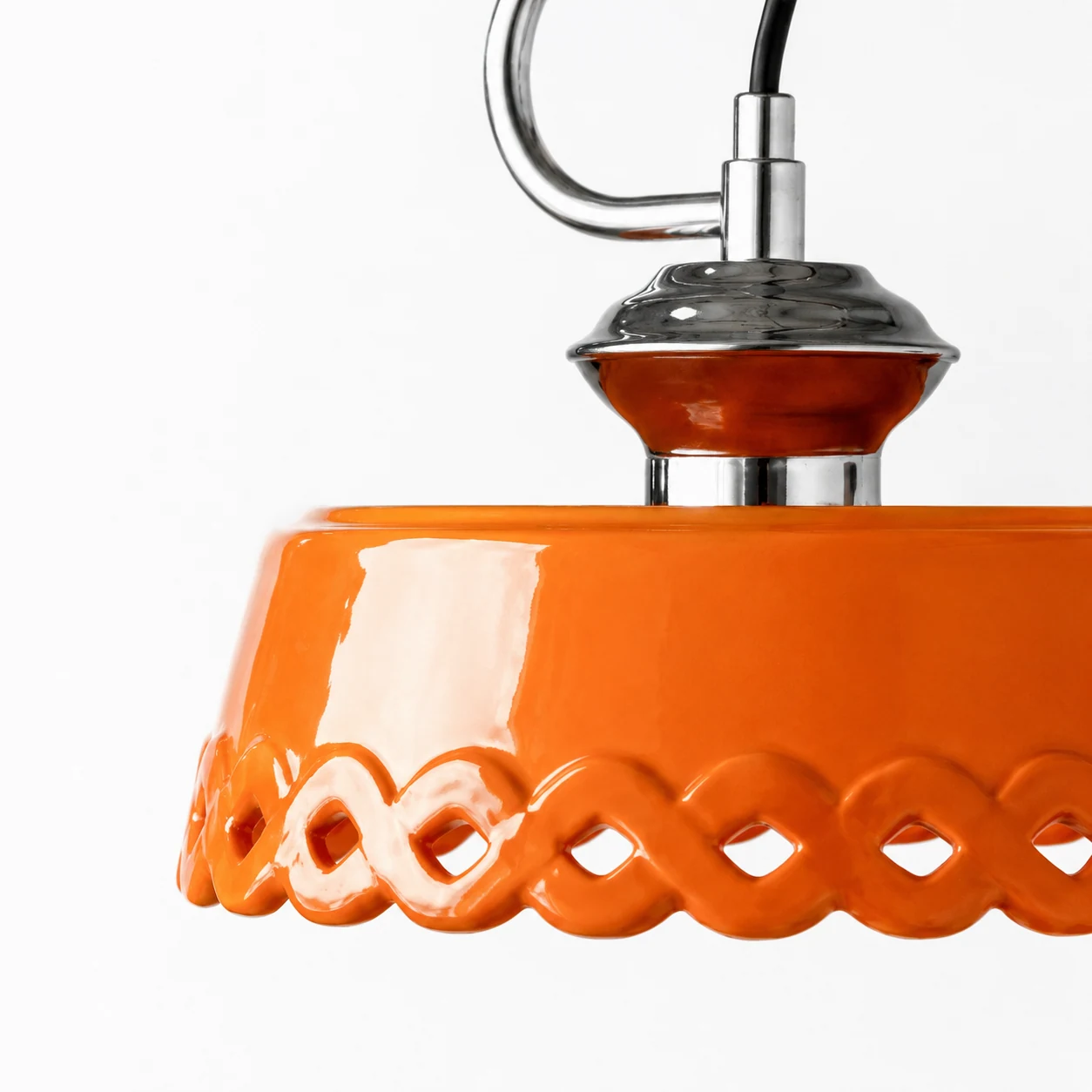 Close-up detail of orange metal and ceramic pendant lamp material and finish