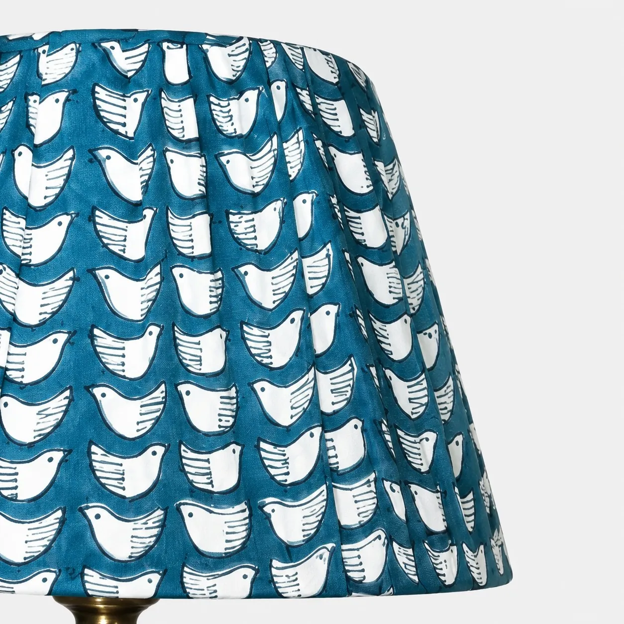Teal pleated fabric shade with white bird pattern detail