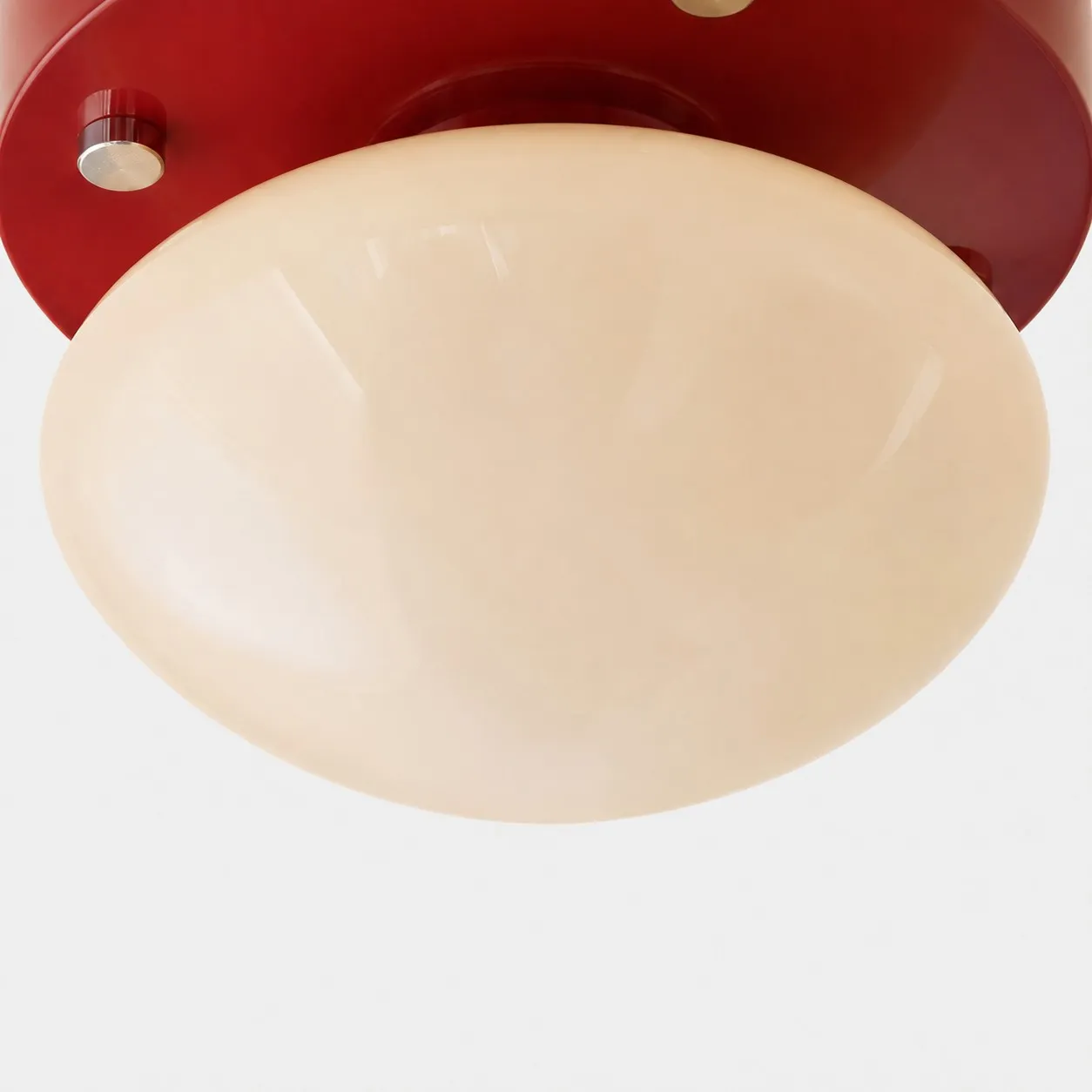 Close-up of cream glass diffuser on red LED ceiling light