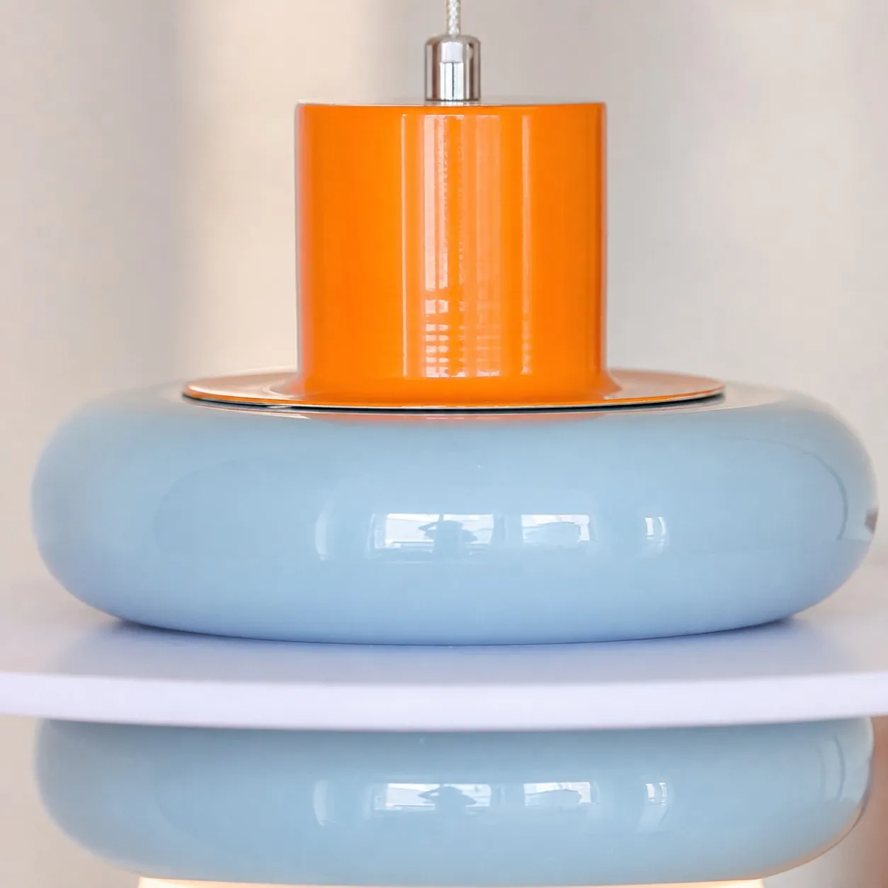 Close-up of sea salt blue layered shade and orange accent