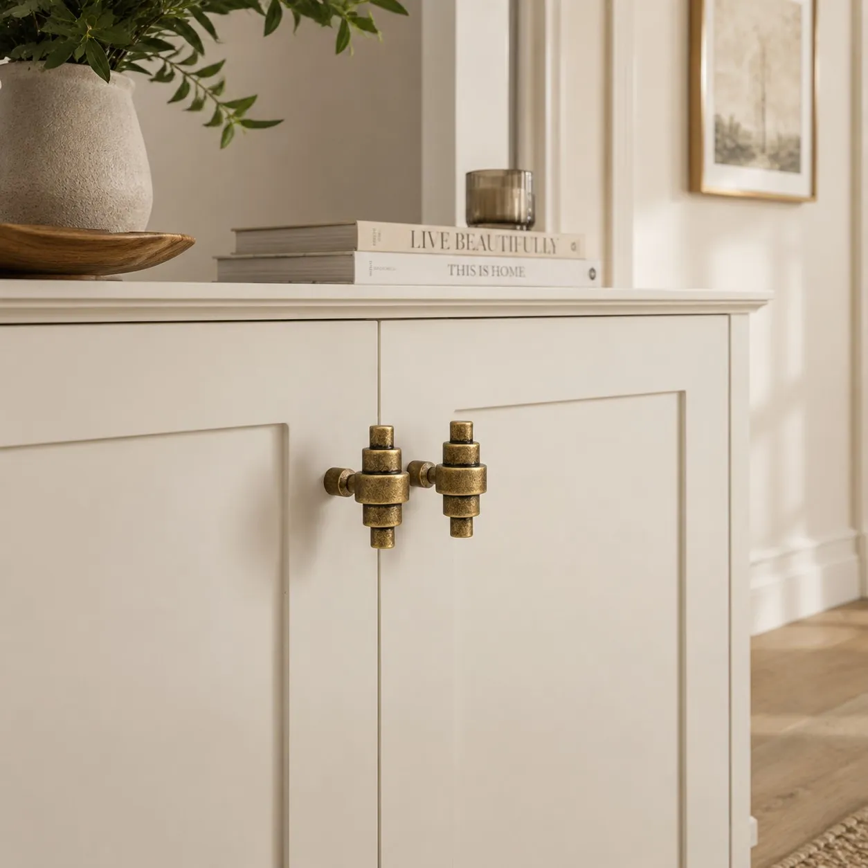 Paired antique brass handles on cabinet doors