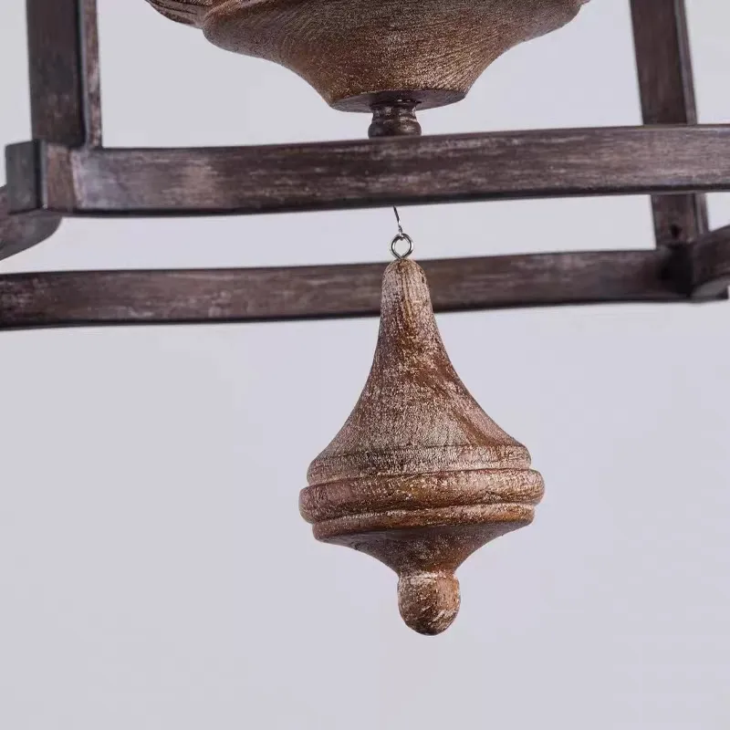 Lower finial and hanging accent detail of rustic birdcage pendant lamp
