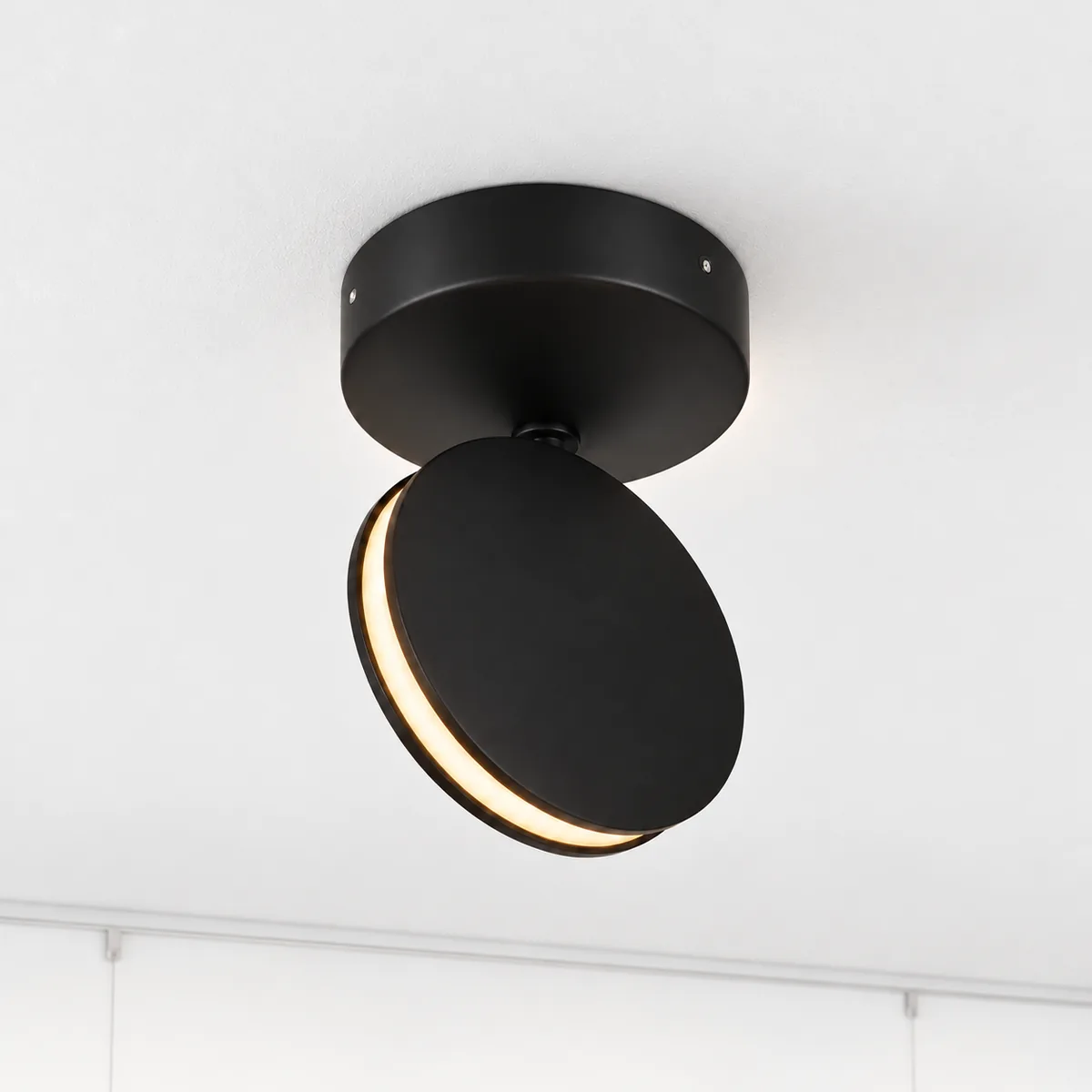 Black aluminium disc LED mounted on the ceiling